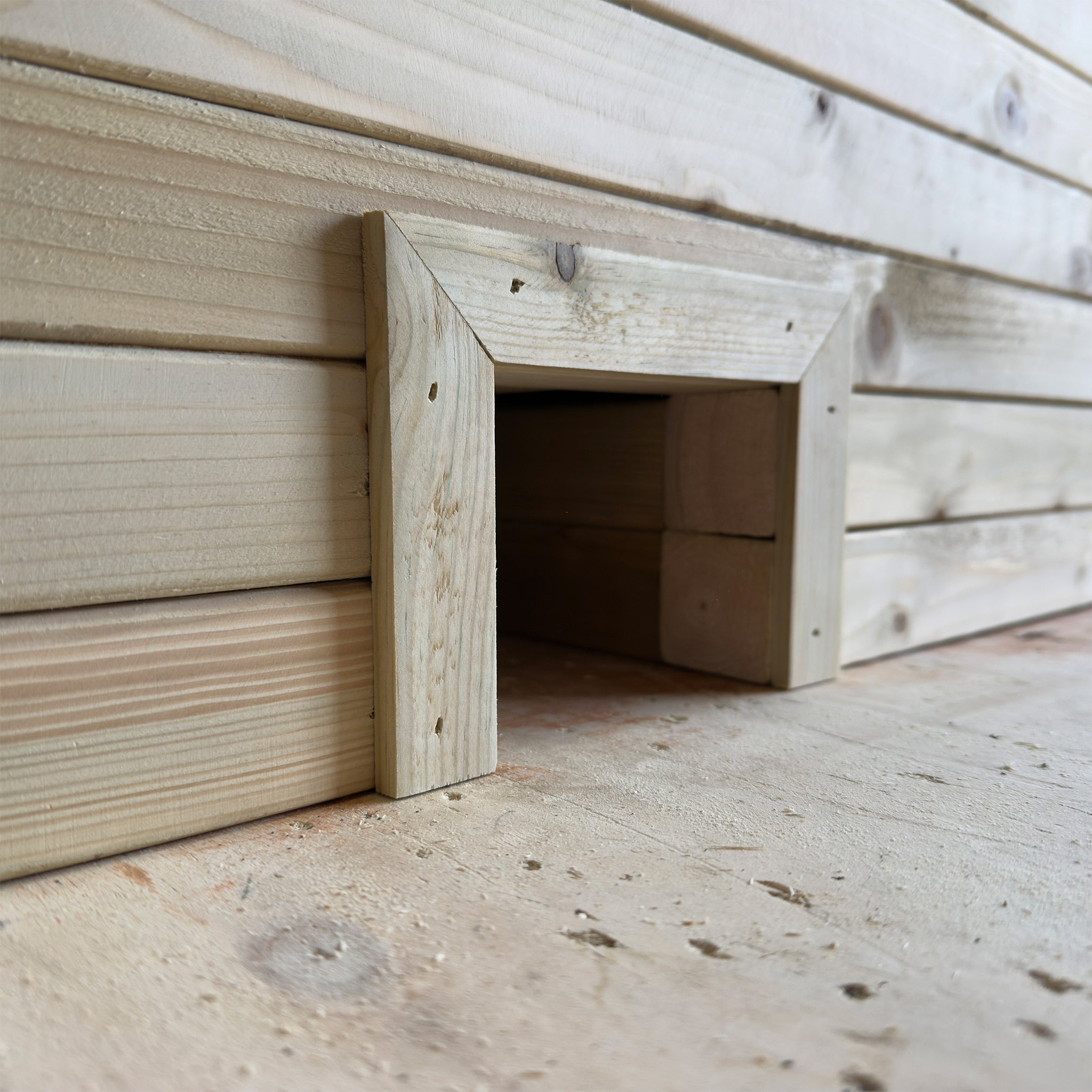 Wooden planter with a built-in hedgehog house