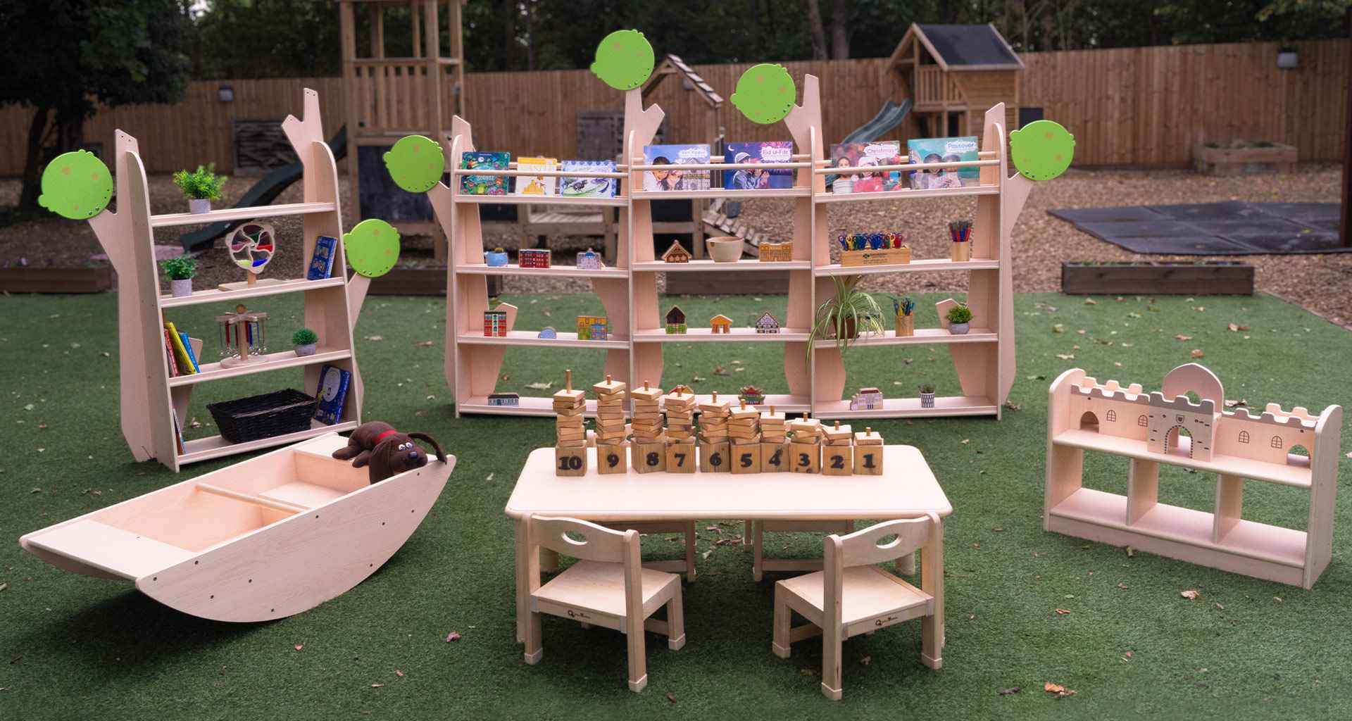 Children's play area with wooden furniture and toys outdoors